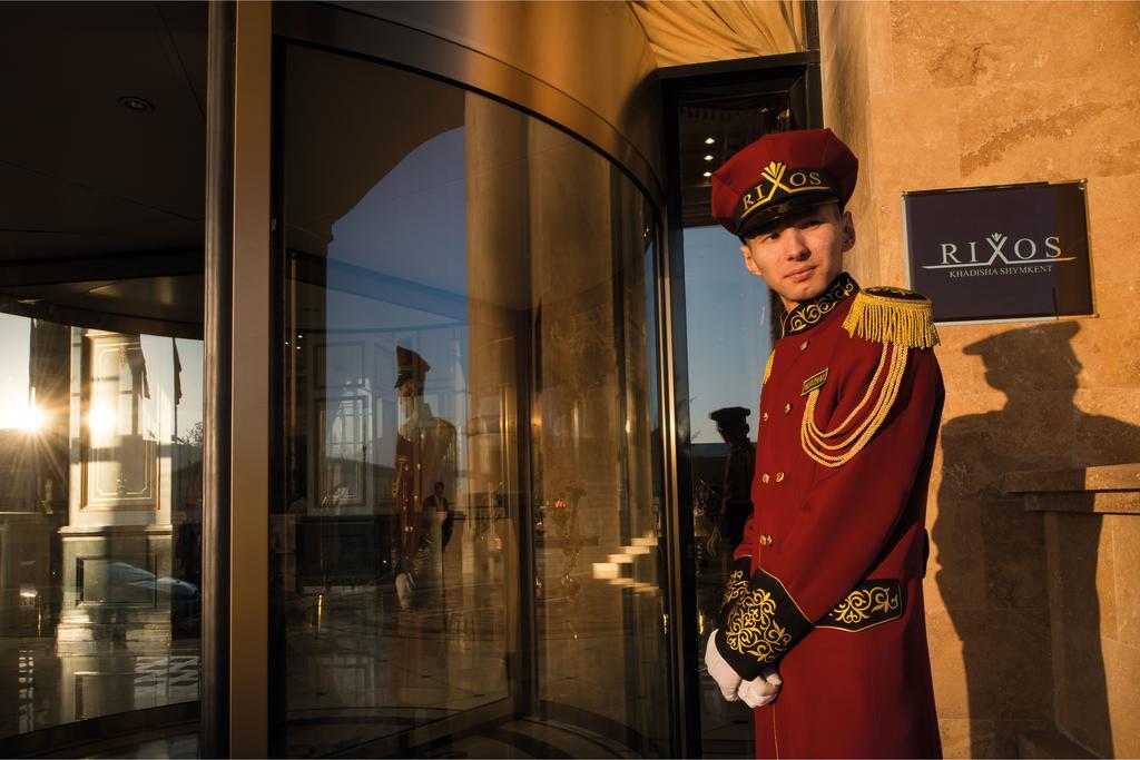 Rixos Khadisha Shymkent Hotel Exterior photo A doorman at the entrance of a hotel